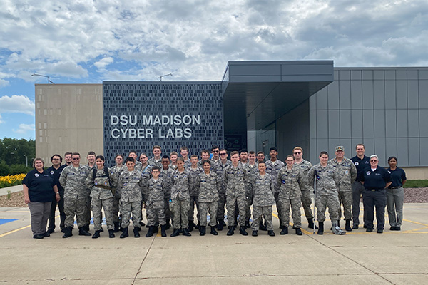 The Civil Air Patrol cadets pose for a photo in front of Dakota State University's MadLabs.